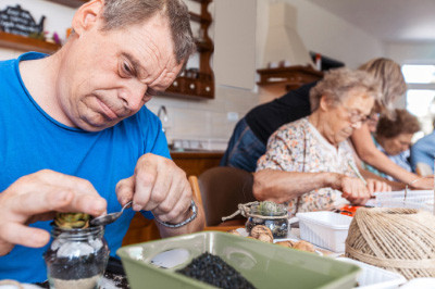 Residents of the Garth Homer Society work on a craft