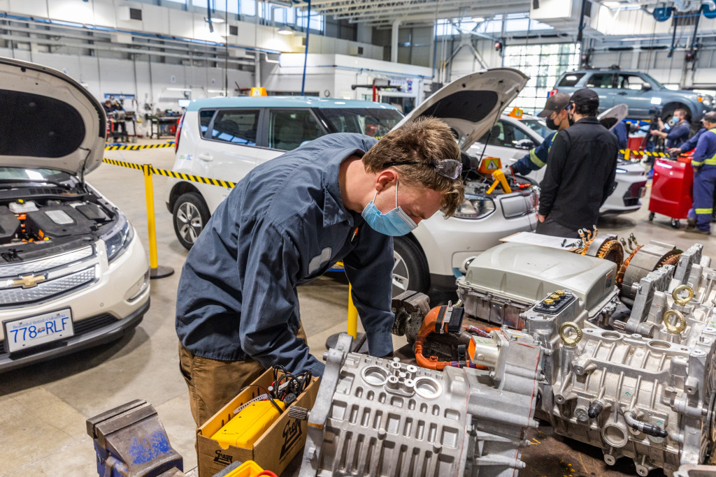 Former student Conall Argue works with an EV training engine in the Camosun automotive classroom.