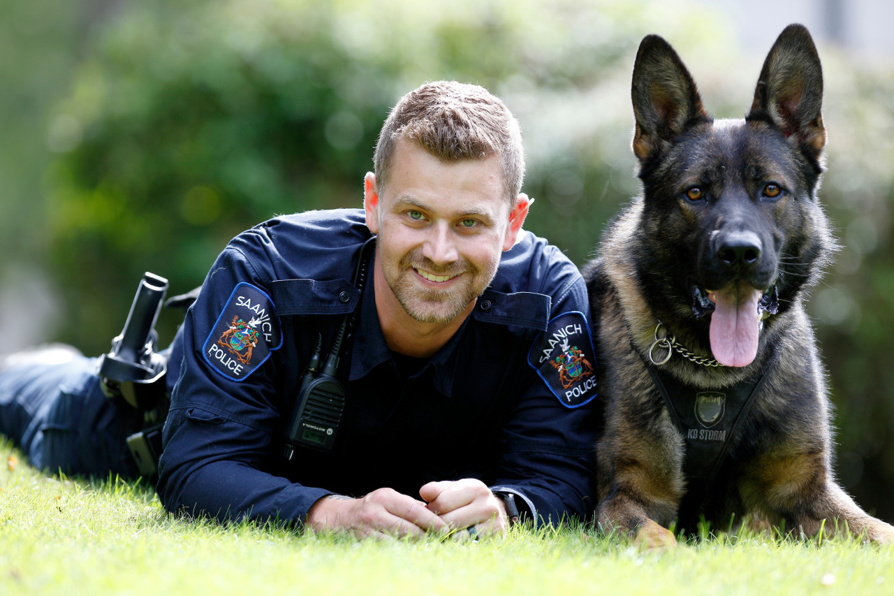 the photo of criminal justice program student now a policeman with a service dog