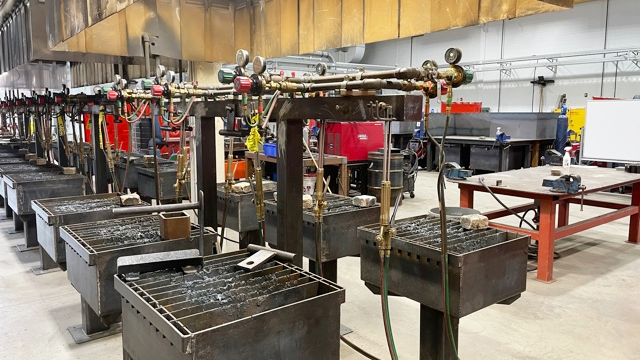 A spacious welding classroom with multiple workstations.