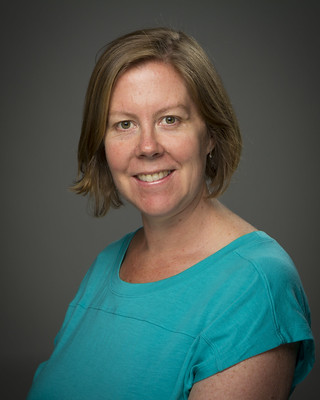 A professional headshot of a woman.