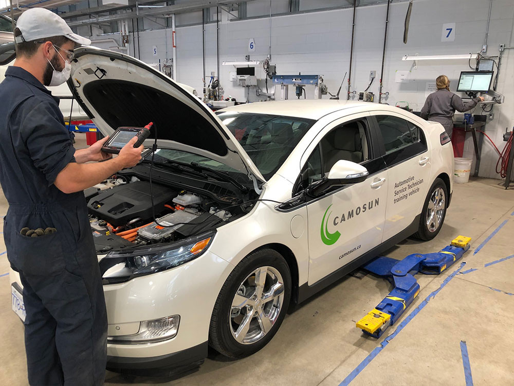 Student working on an electric vehicle