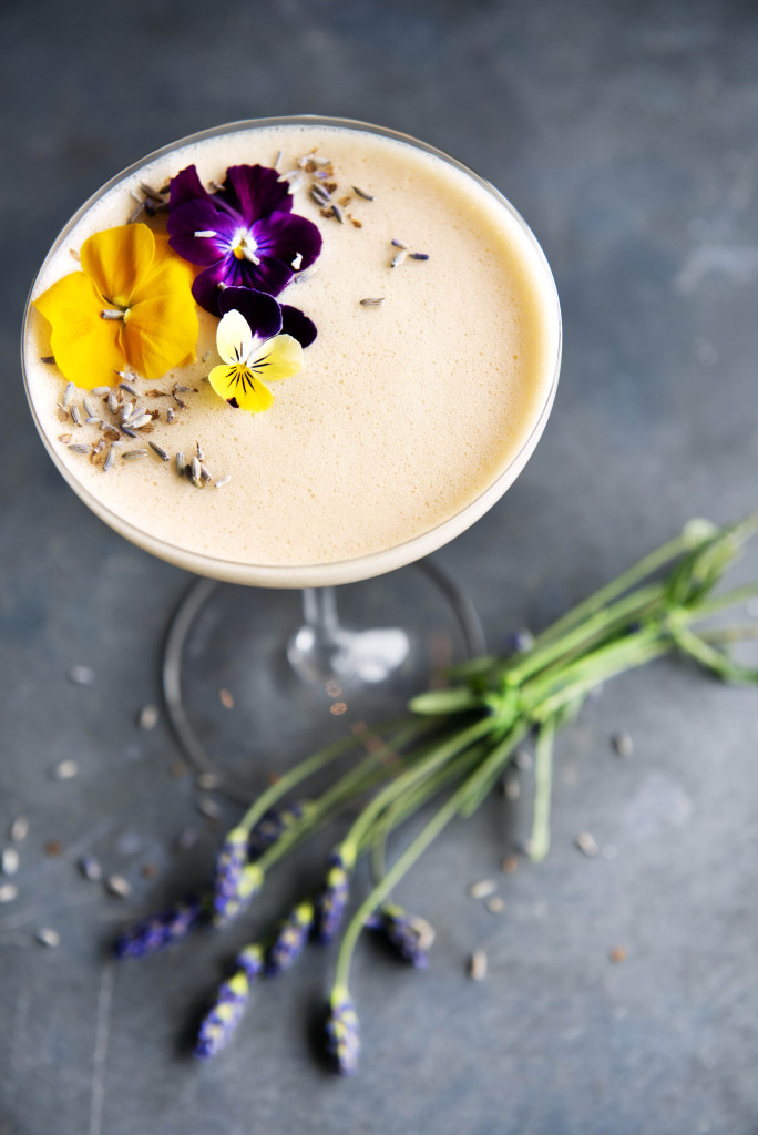 Earl Grey martini decorated with flowers on a grey background