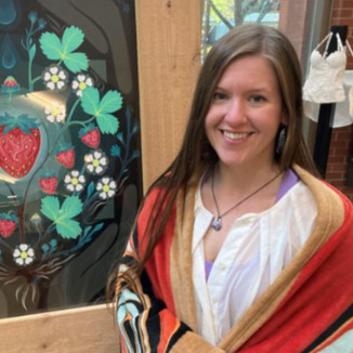 Indigenous Studies student Alisha Parks unveils an original painting.  