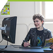 Rhys, a Comics & Graphic Novel program student in the computer lab