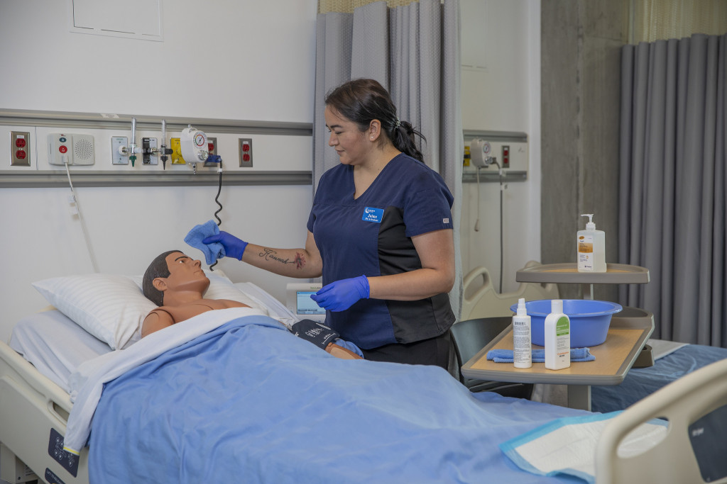 Jaime, a Health Care Assistant student working in the teaching lab