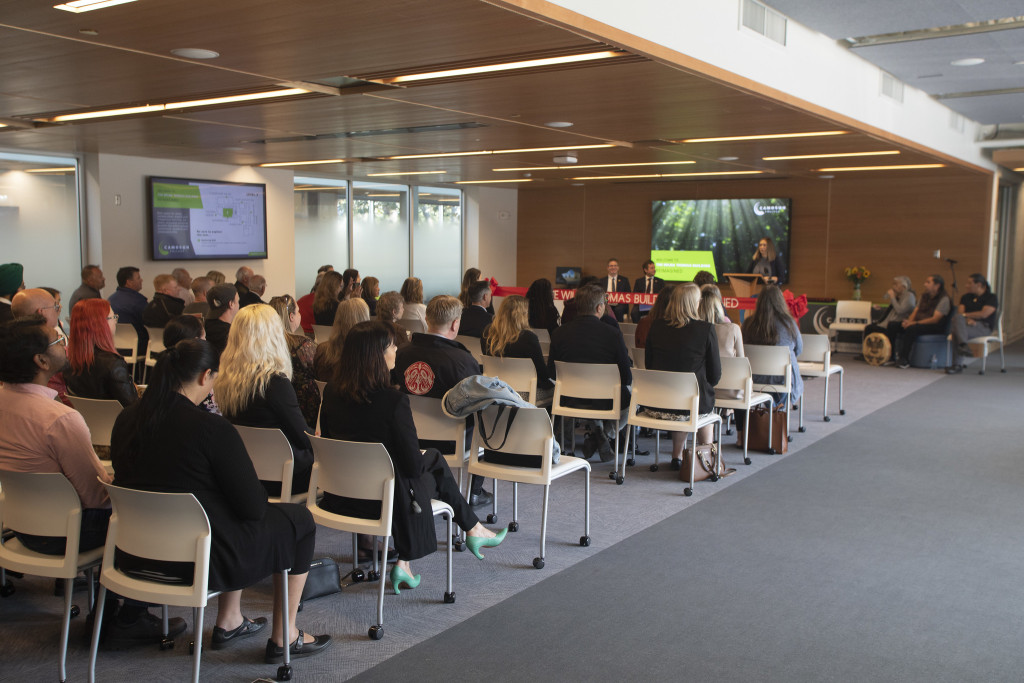 People are seated in the new celebration hall during the official opening ceremony