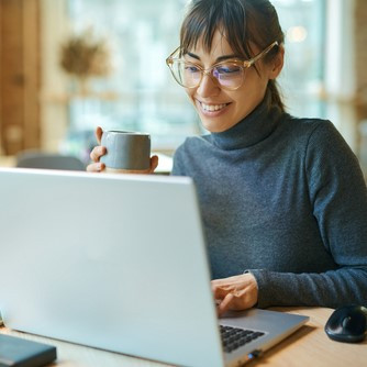 Woman seated in front of a laptop