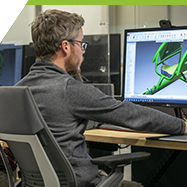 Student sitting in front of a screen using engineering graphics software.