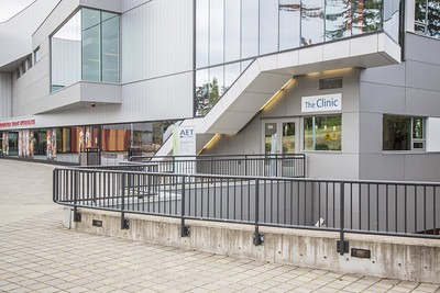 The exterior entrance to the clinic. A large sign that says "The Clinic" is hung above the door.