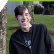 Kaleb standing outdoors smiling at the Interurban Campus