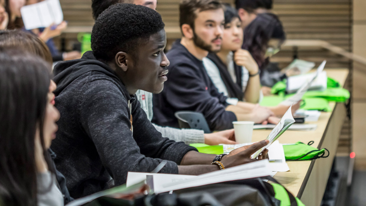 A student listens intently during an orientation session 