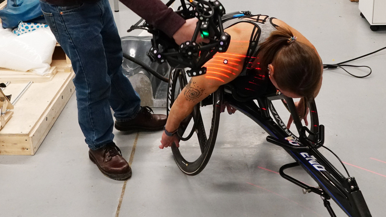 An athlete is fitted for a high technology custom racing chair
