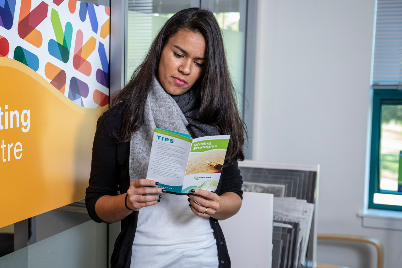 A college student waits for her appointment at the Writing Help Centre