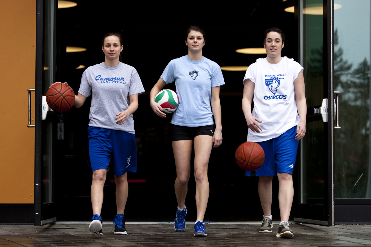 A photo of three women strutting with basketballs