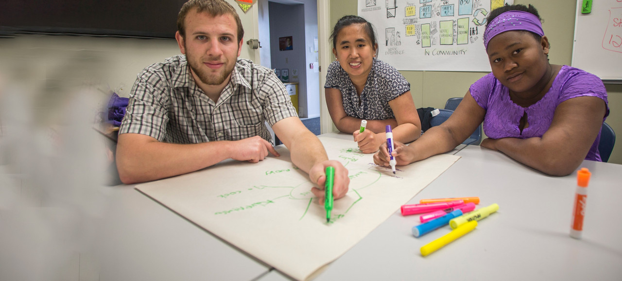 Three students drawing storyboard