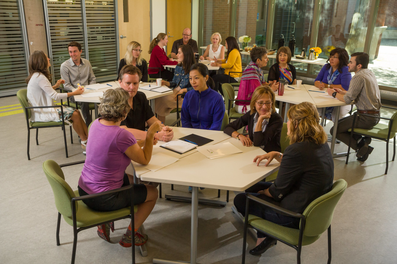 Groups of people sitting at tables talking