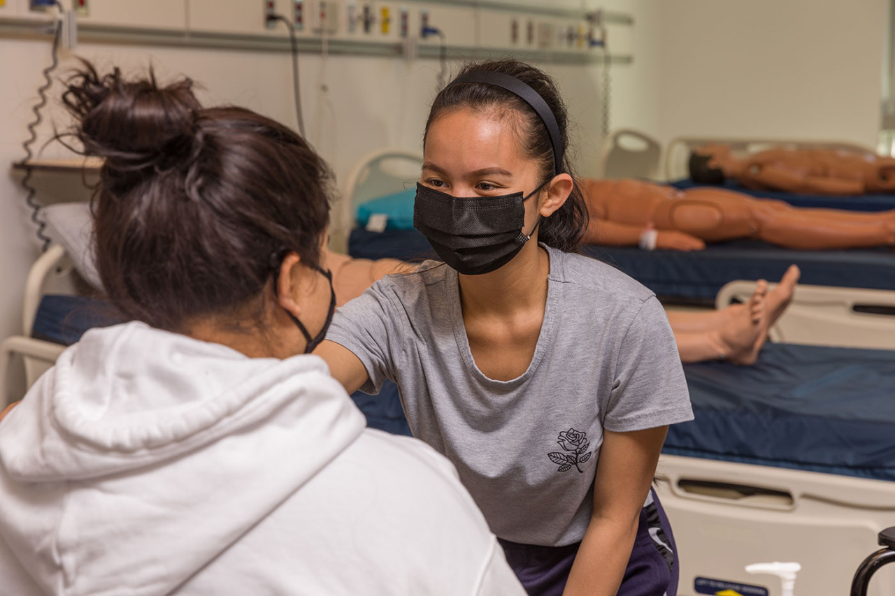 Health Care Assistant students hands-on learning in lab