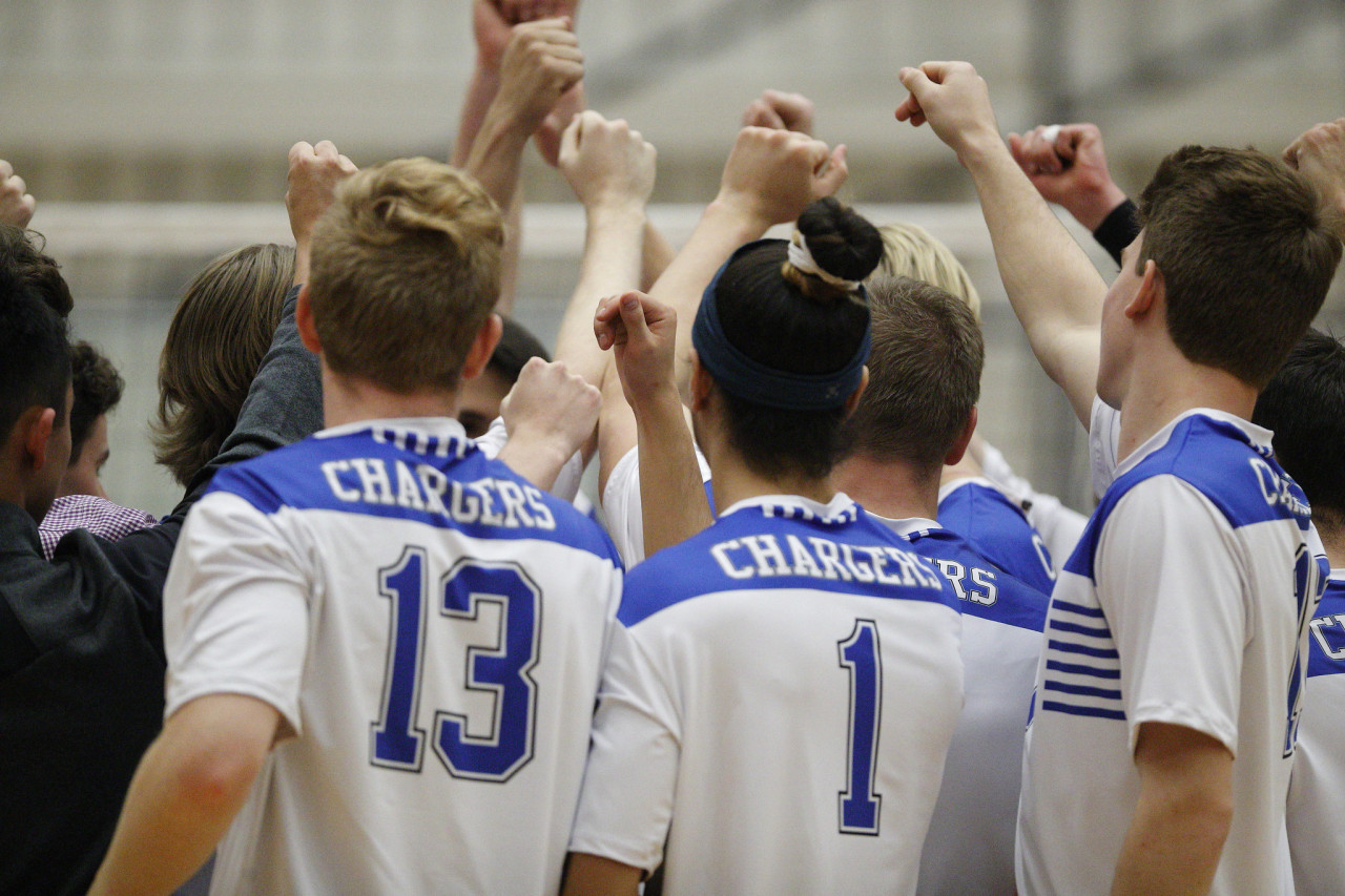 Camosun Athletes gathering in a huddle to cheer