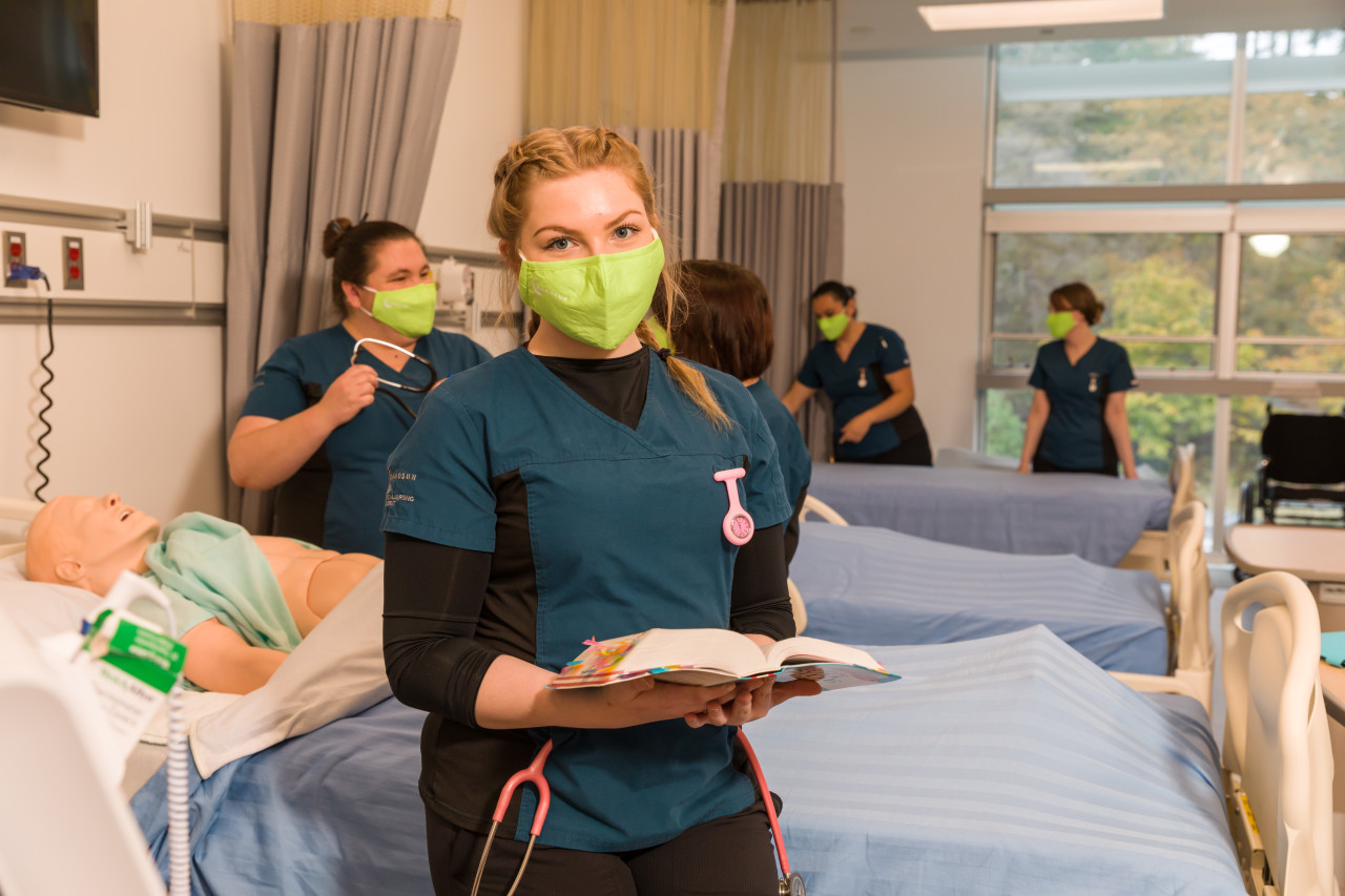 Practical Nursing Student Holds Book