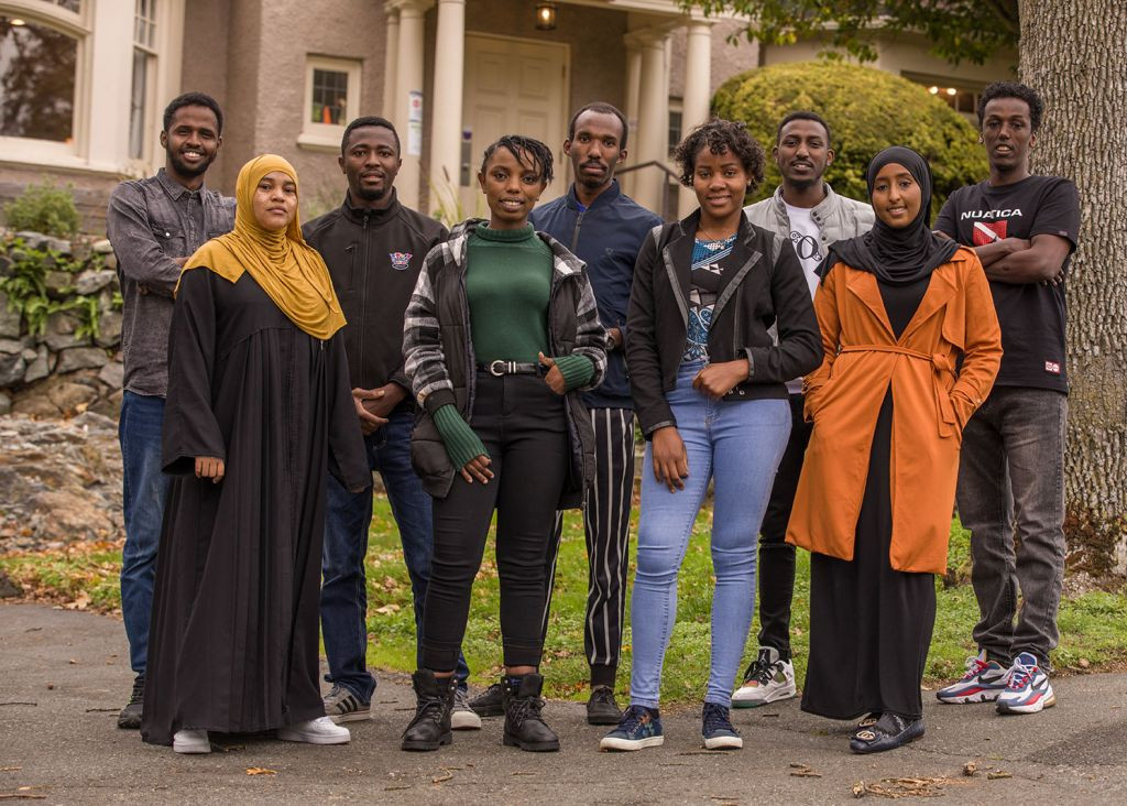 Nine refugee youth pose for a picture on the lawn at Camosun College