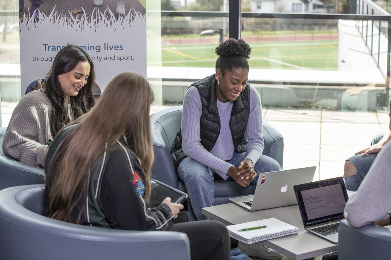 group of students studying in building lobby