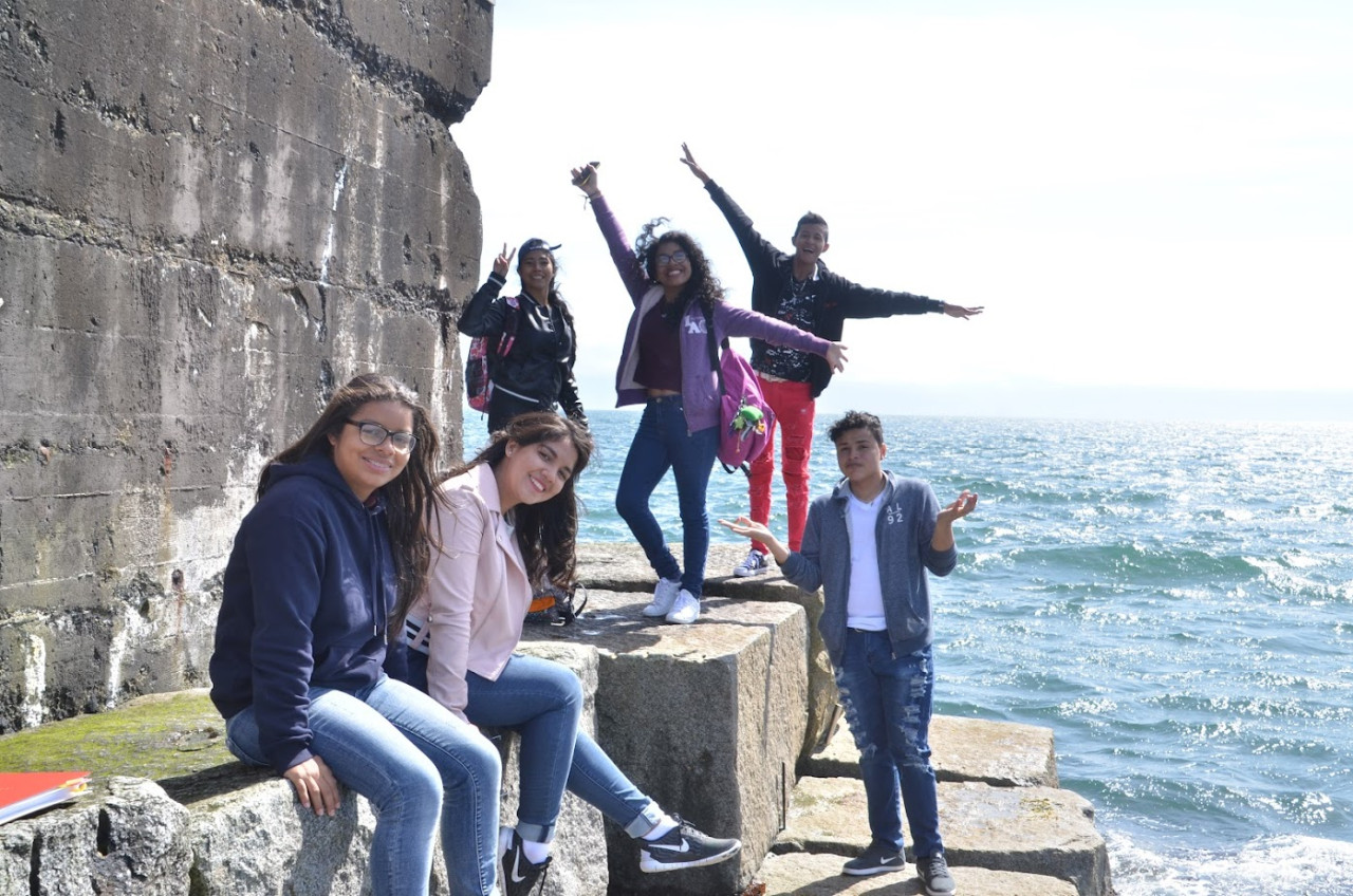 CELA Students by an ocean wall. They are mugging for teh camera.