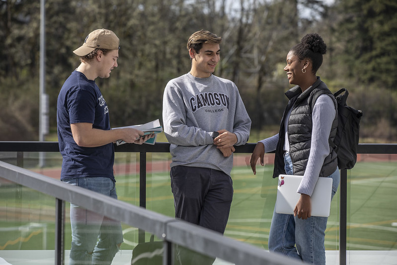 Micah (centre) with friends outside the PISE building