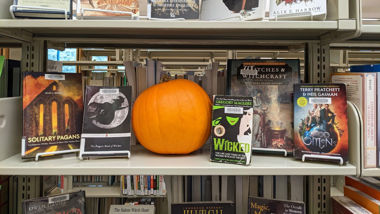 A display shelf of Halloween themed books.