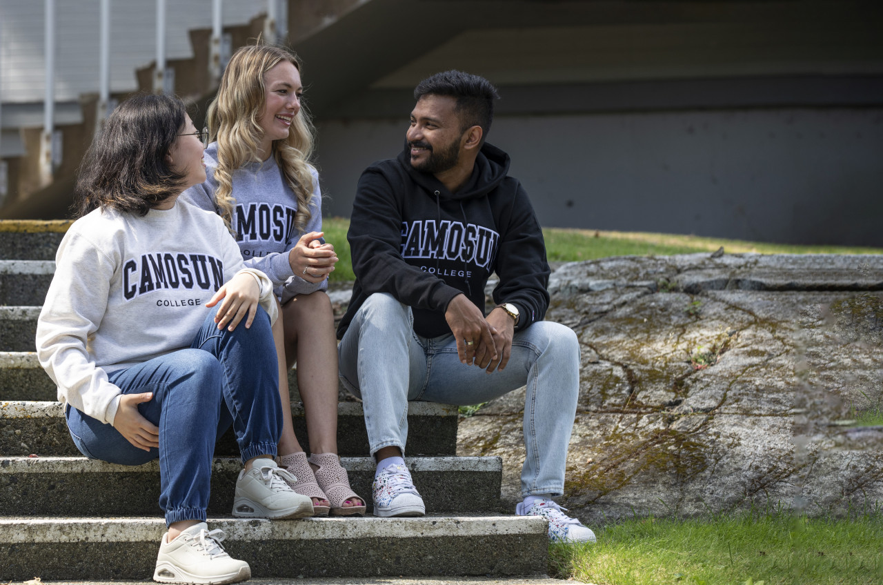 Three Camosun students on stairs