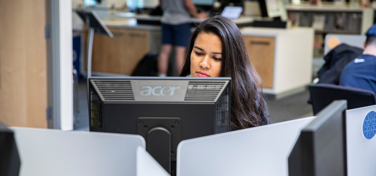 A Camosun student using the computers in the library