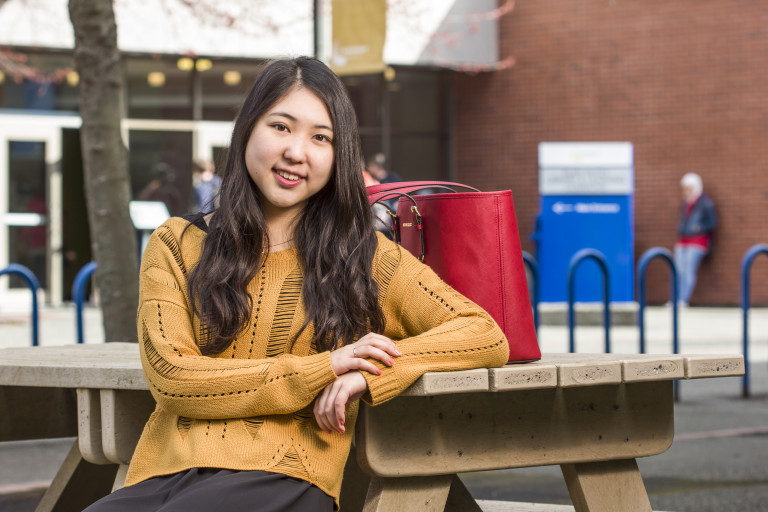 A Camosun student sits outside enjoying the sunshine.