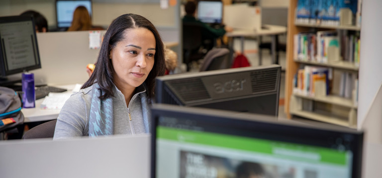 A Camosun student works at a computer in the Library