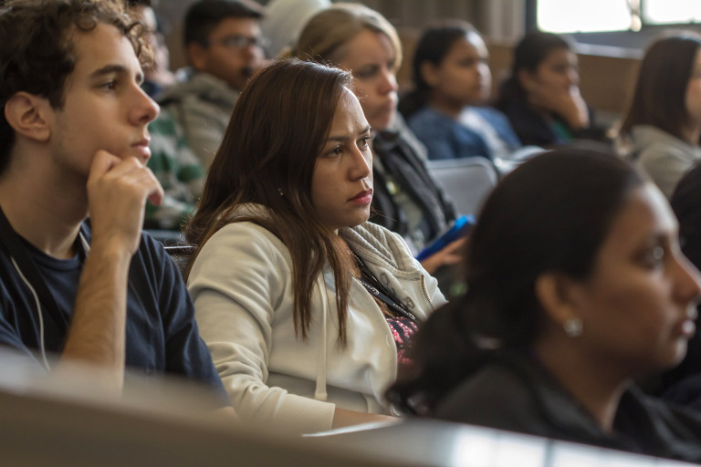 A young woman listens intently in class