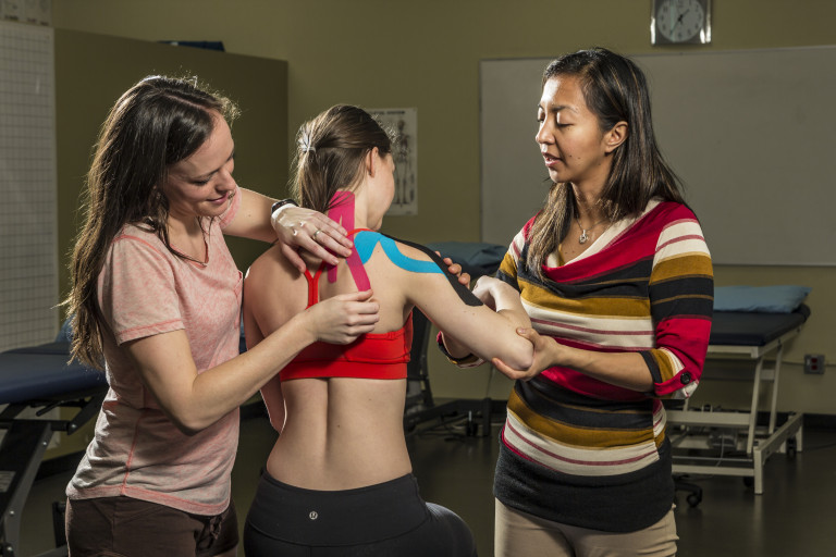 Jen Gow instructing a student on a taping technique