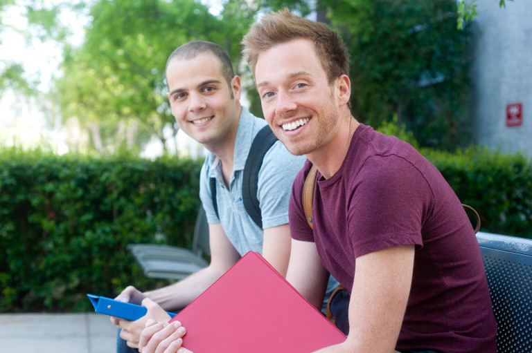 Two students sitting on a bench