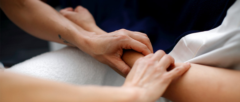 Student massaging a client's arm