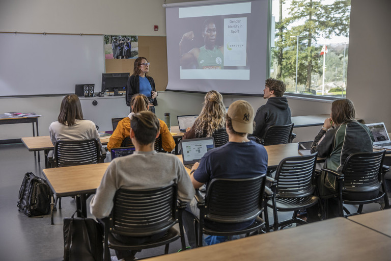 sport management instructor lecturing a room of students