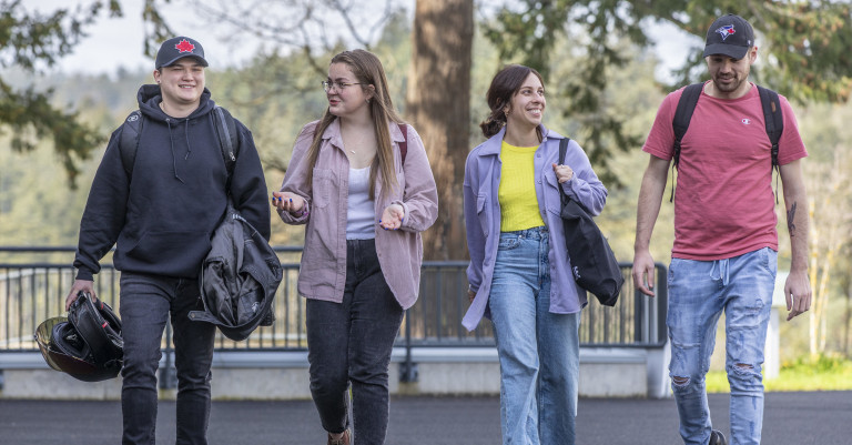 Four students walking to class outside