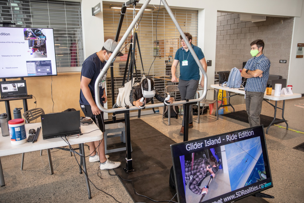 Four students testing a glider simulator at the mechanical engineering capstone