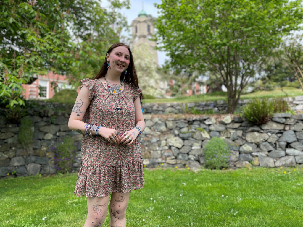 Student portrait showing a woman standing in the lawns outside of the Young Building on Camosun College's Lansdowne campus