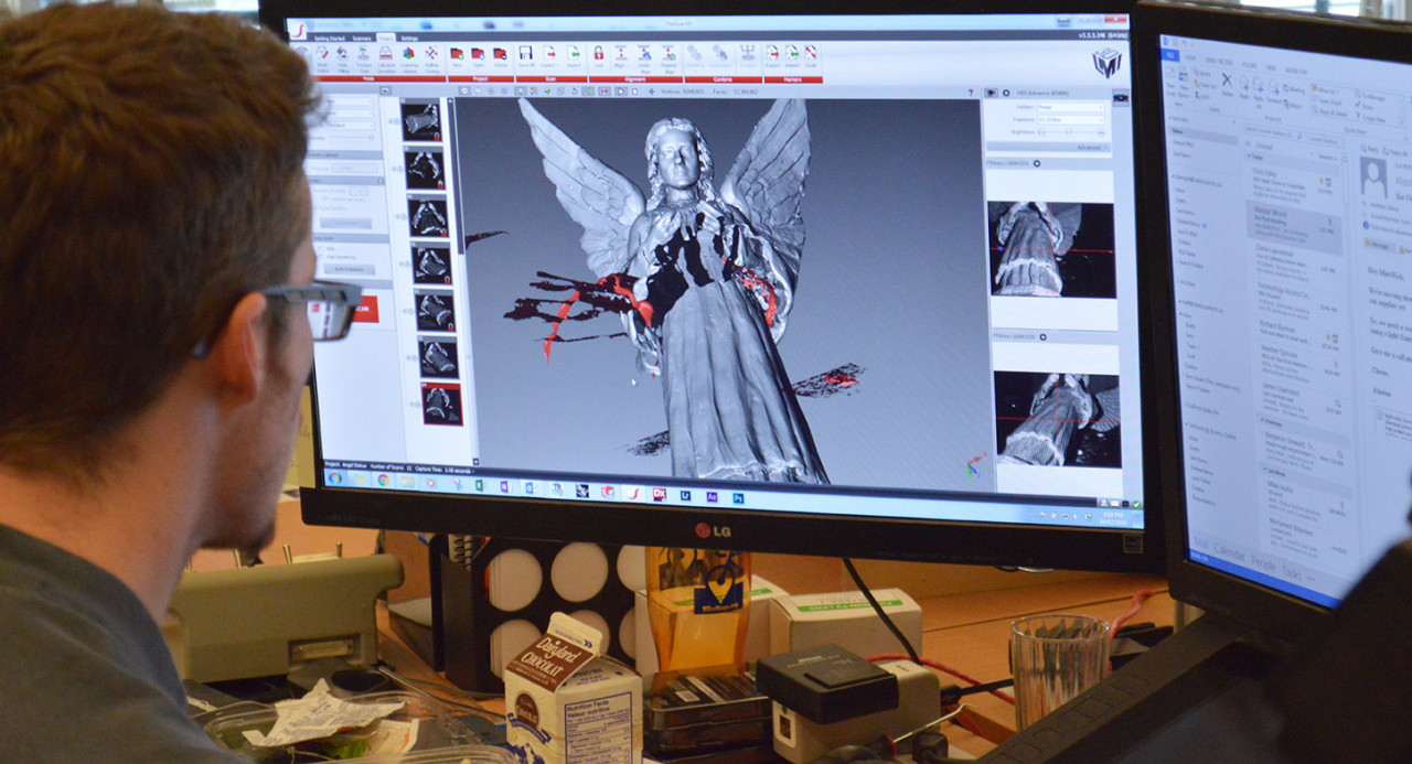 A technician renders a 3D model of an angel sculpture 