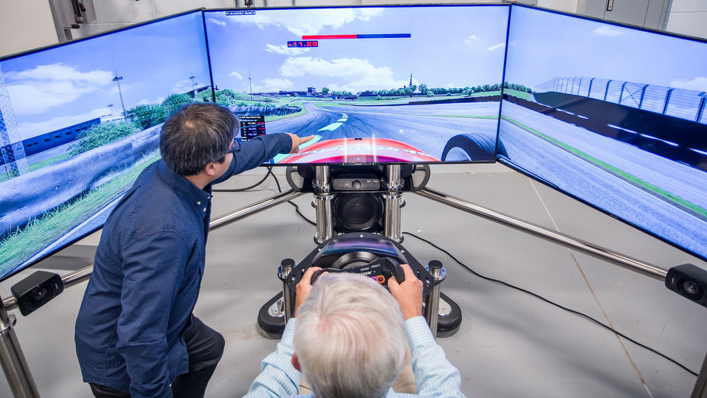 A person in a high tech driving simulation machine 