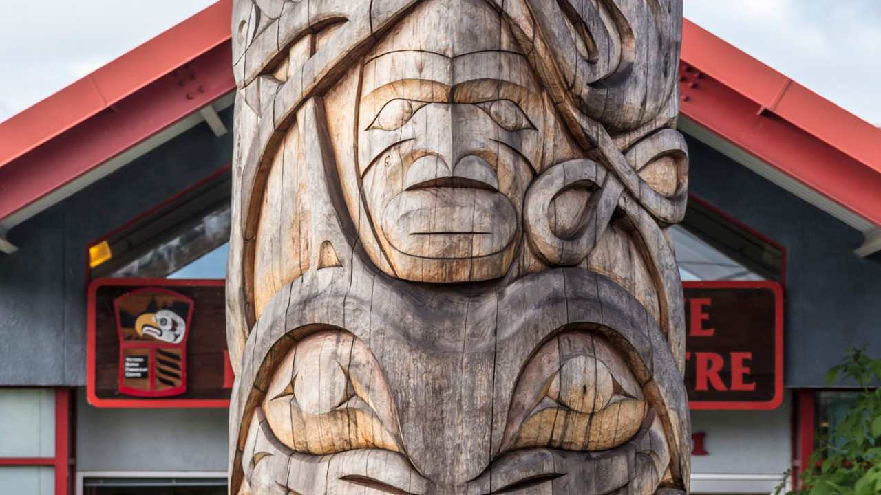 An extreme close up of a totem pole on campus