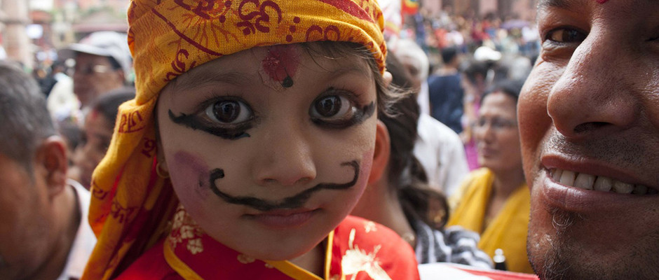 small child with painted mustache at cultural festival
