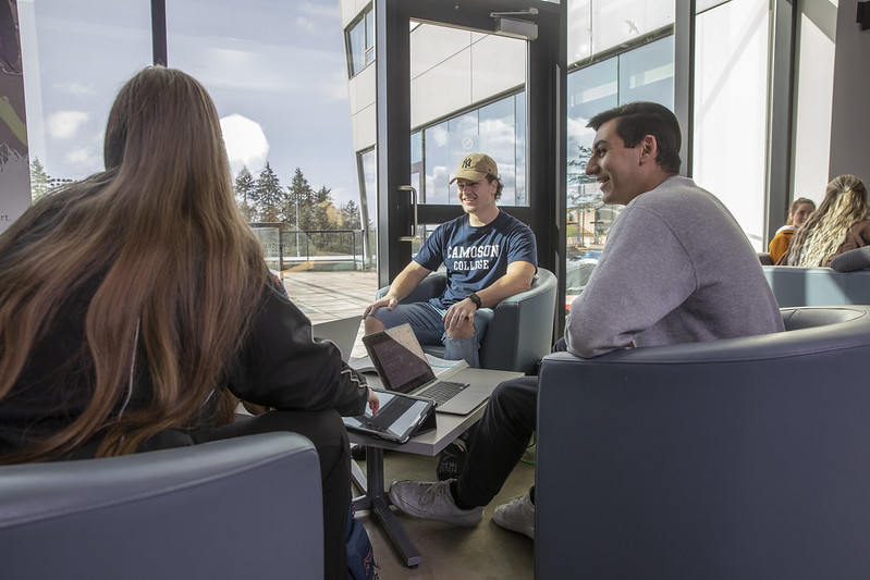 Micah (centre) with fellow Sport Management students inside the PISE building