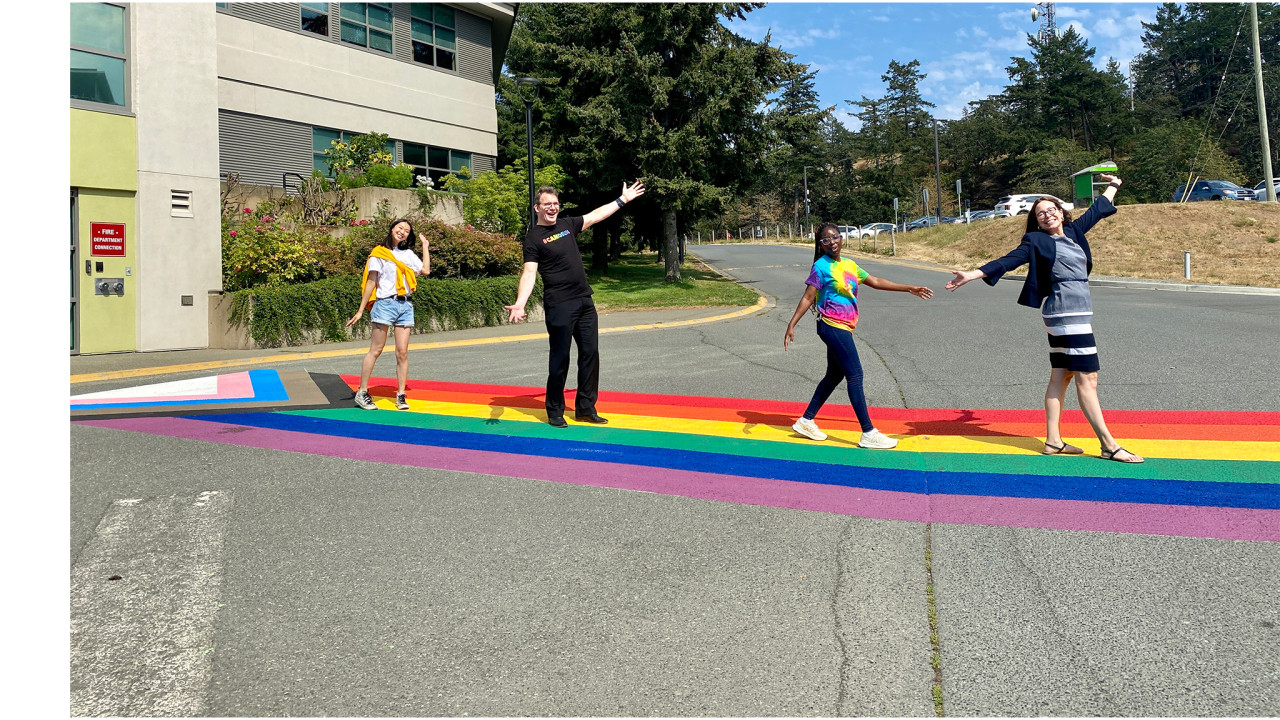 Students and college administrators walk across the pride crosswalk at Interurban campus