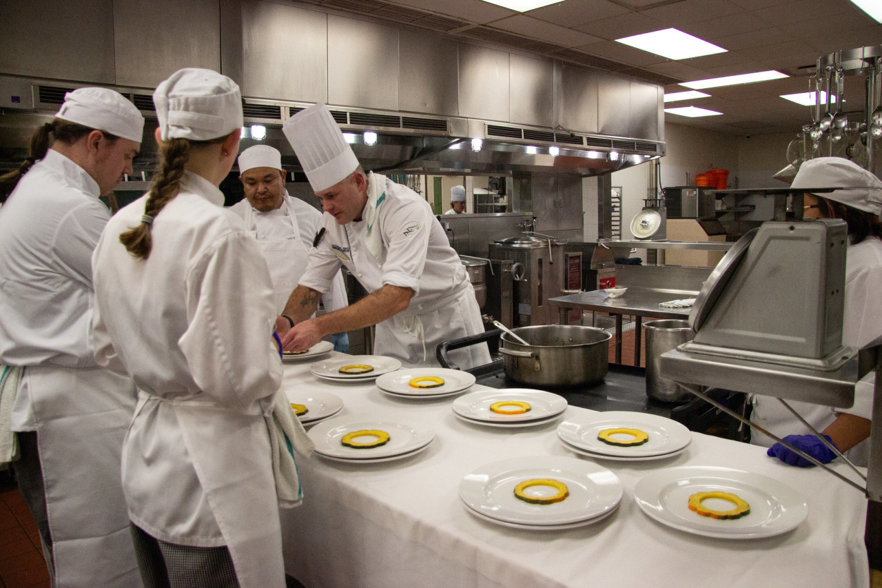 Instructor with students in Professional Cook Training program
