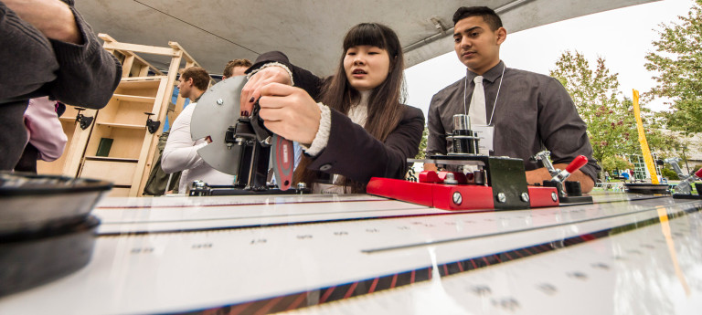 Students explain their projects at a Mechanical Engineering Capstone event