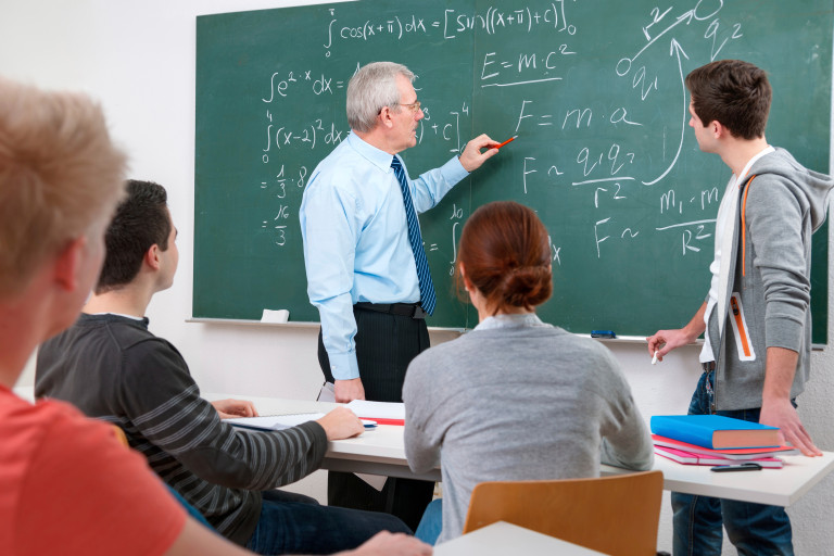 Instructor writing on blackboard